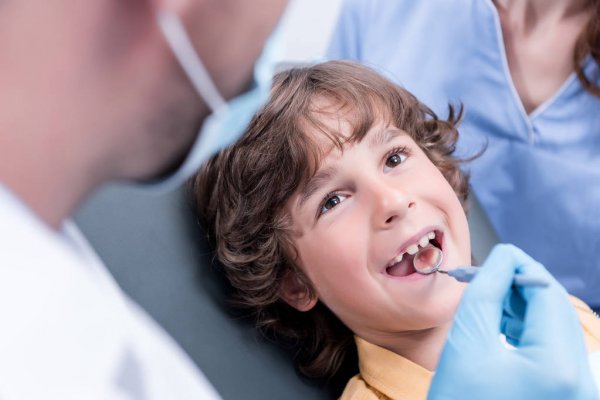 depositphotos_159664898-stock-photo-dentist-examining-patients-teeth